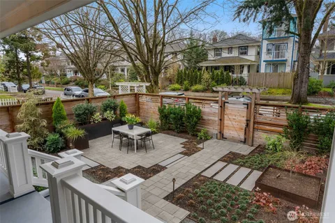 a view of a patio with couches table and chairs and potted plants