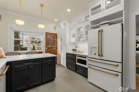 a kitchen with stainless steel appliances granite countertop a stove and a refrigerator