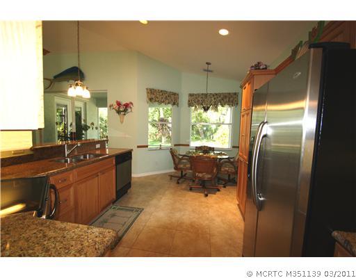585 Southwest Rustic Circle Stuart, FL 34997 - Photo 16 of 16 Kitchen. wonderful kitchen with breakfast area that overlooks the screened porch and backyard