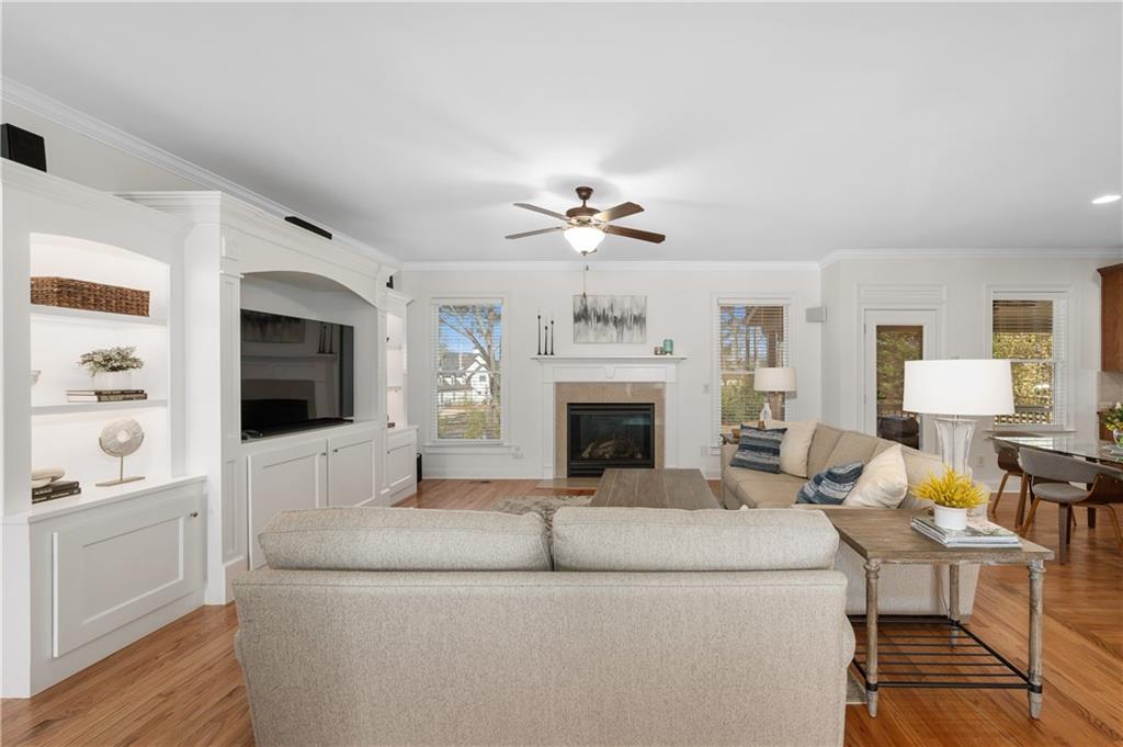 5740 Cascade Trail Cumming, GA 30040 - Photo 12 of 64 a living room with furniture a fireplace and a flat screen tv