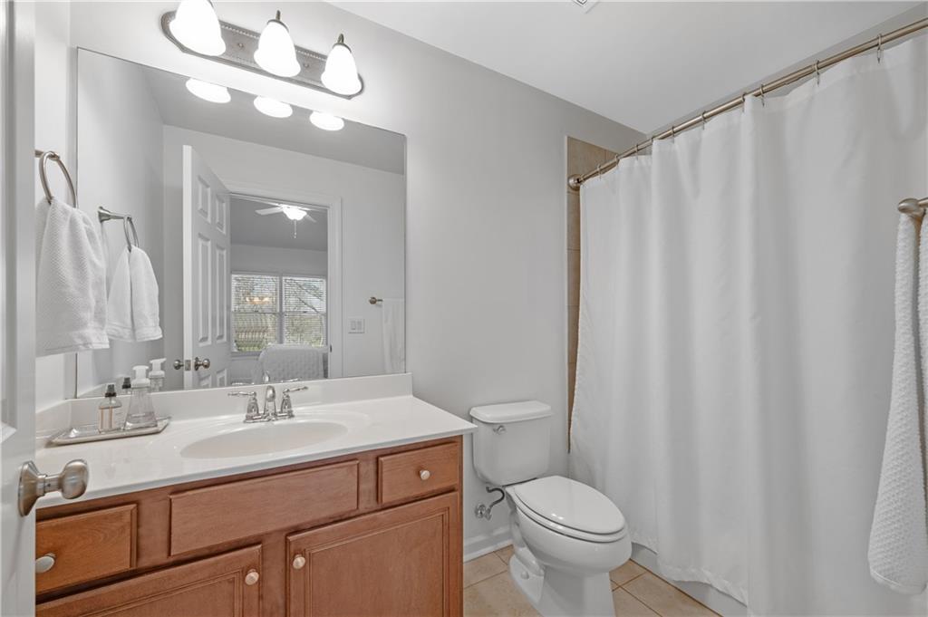 5740 Cascade Trail Cumming, GA 30040 - Photo 32 of 64 a bathroom with a double vanity sink mirror and toilet