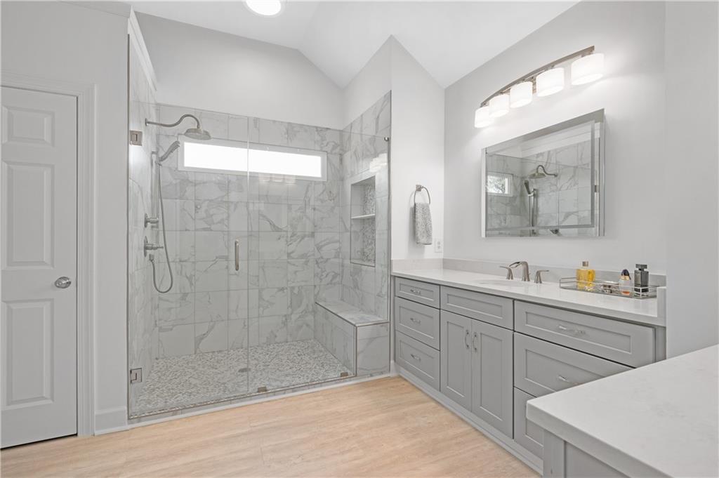 5740 Cascade Trail Cumming, GA 30040 - Photo 37 of 64 a bathroom with a double vanity sink mirror and shower