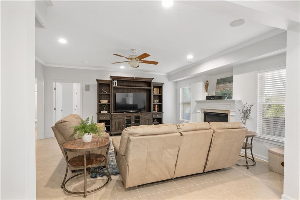 5740 Cascade Trail Cumming, GA 30040 - Photo 42 of 64 a living room with furniture a fireplace and a flat screen tv