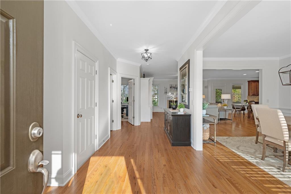 5740 Cascade Trail Cumming, GA 30040 - Photo 6 of 64 a view of a hallway view with wooden floor and dining room
