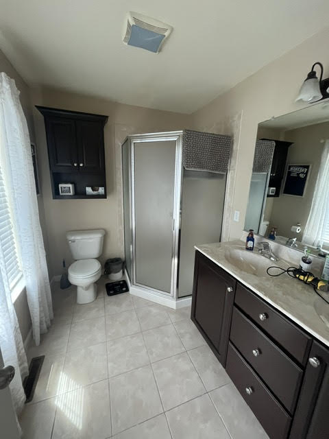 2212 Rising Hill Road Whitehall, PA 18052 - Photo 13 of 21 Ceramic tile flooring spans this well-appointed bathroom featuring a glass-enclosed shower and a vanity with ample storage.
