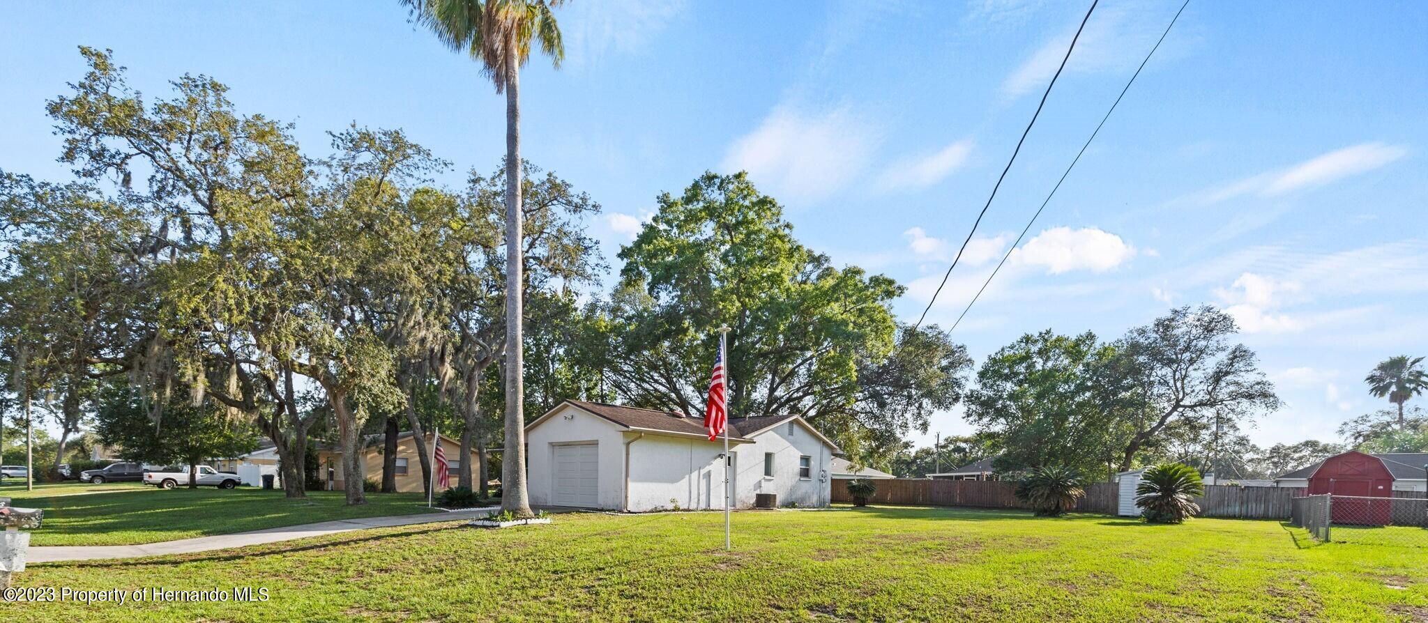 129 Candlewick Avenue Spring Hill, FL 34608 - Photo 2 of 28 3 cropped side yard 129