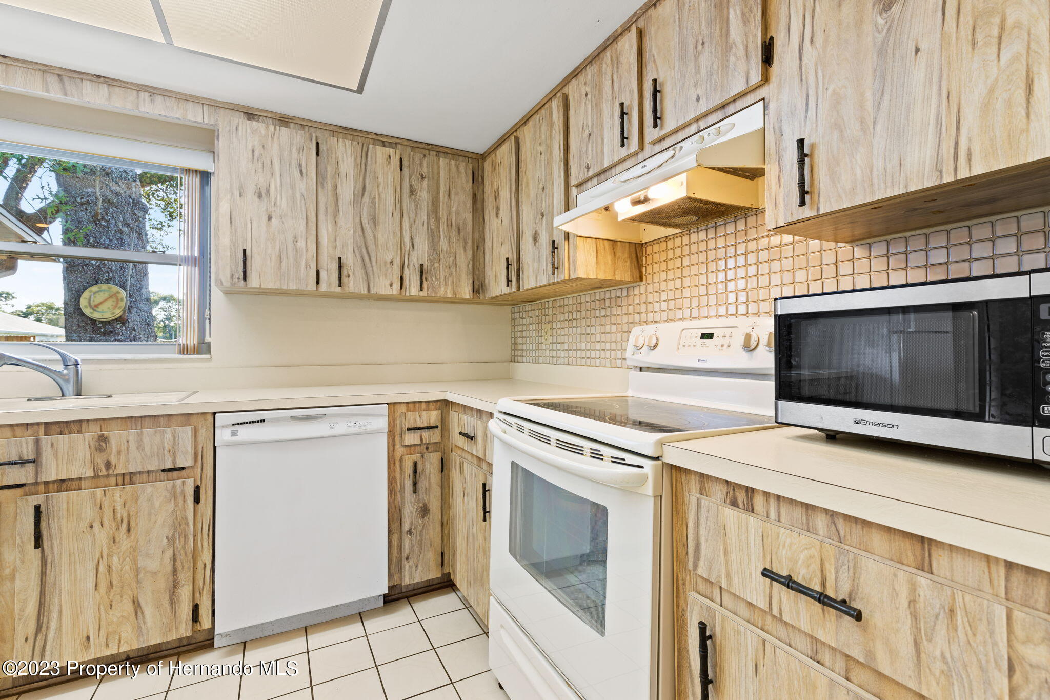 129 Candlewick Avenue Spring Hill, FL 34608 - Photo 8 of 28 12-close up of kitchen stove and dishwas