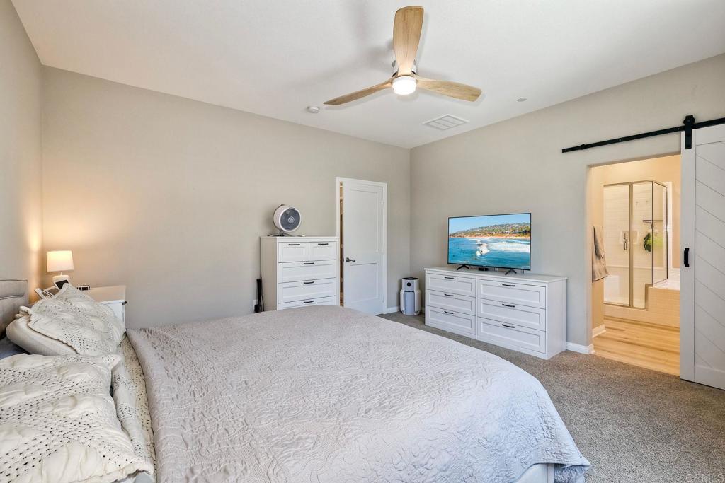 1715 Crabapple Way Oceanside, CA 92056 - Photo 12 of 31 a bedroom with a bed and a chandelier