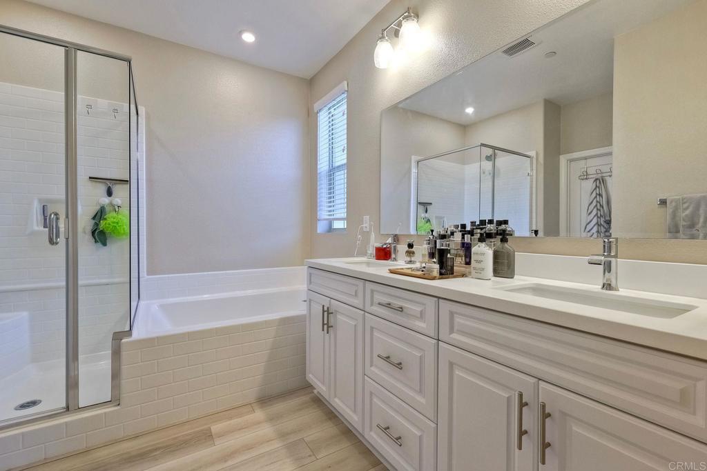 1715 Crabapple Way Oceanside, CA 92056 - Photo 13 of 31 a bathroom with a double vanity sink and a bathtub