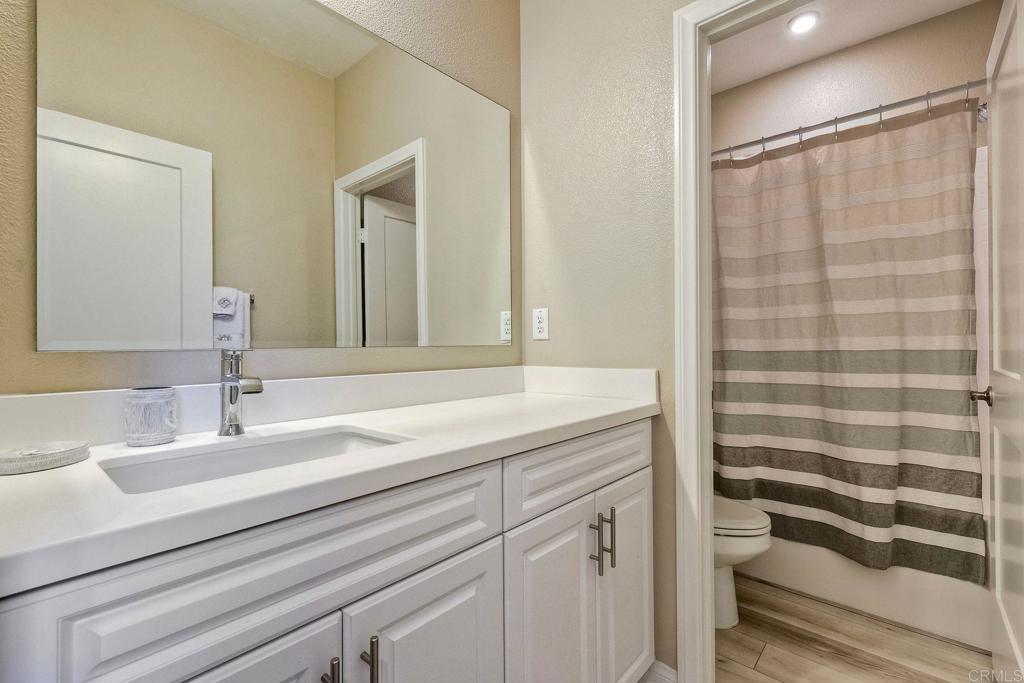 1715 Crabapple Way Oceanside, CA 92056 - Photo 18 of 31 a bathroom with a sink and a mirror