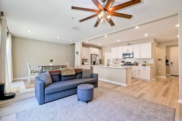 a living room with furniture and kitchen view