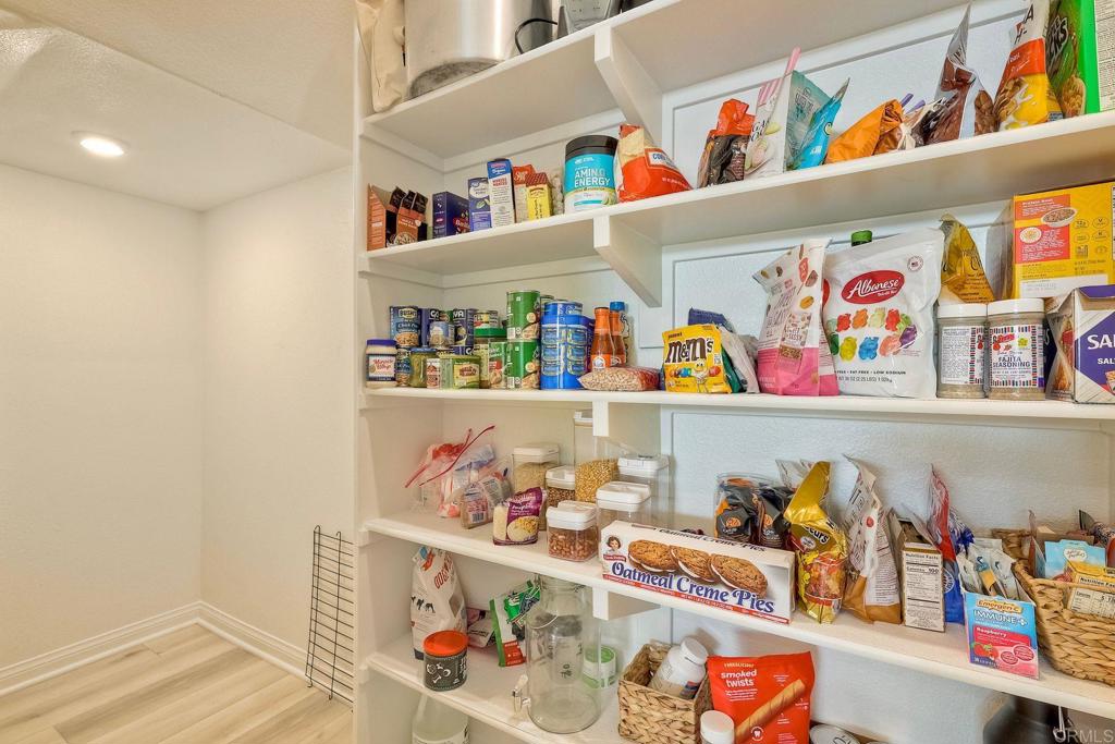 1715 Crabapple Way Oceanside, CA 92056 - Photo 9 of 31 a store room with lots of clutter and refrigerator