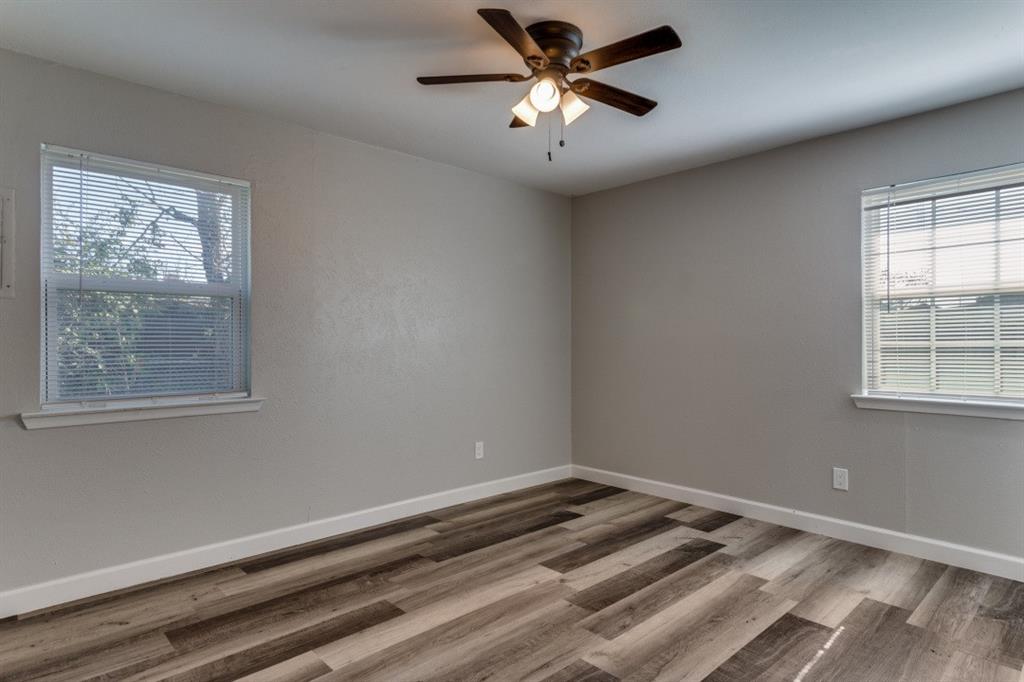 809 Michelle Drive Everman, TX 76140 - Photo 6 of 11 a view of a big room with wooden floor and windows