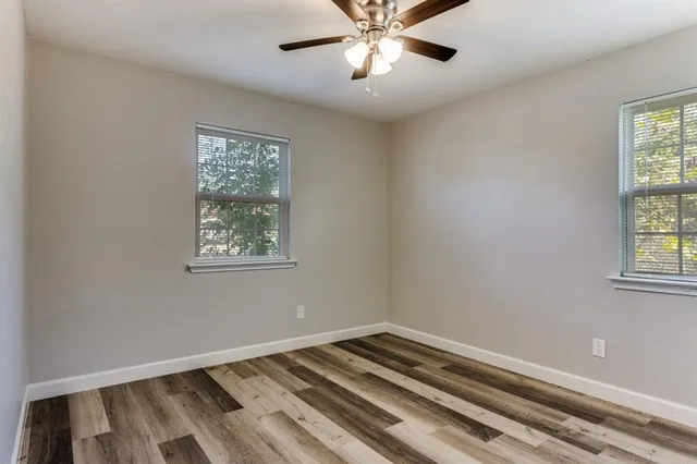 a view of room with window and ceiling fan