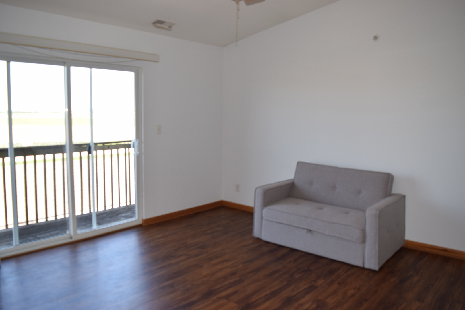565 North Strack Street, Unit 302 Cortland, IL 60112 - Photo 2 of 15 a living room with wooden floor and a window