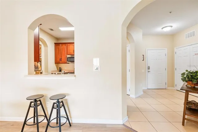 a kitchen with stainless steel appliances granite countertop a sink and a refrigerator