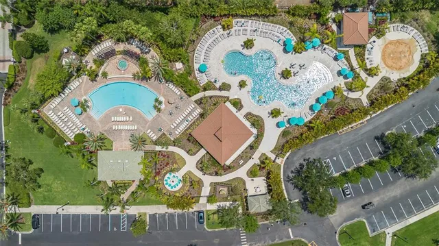 an aerial view of a house with a swimming pool and outdoor seating