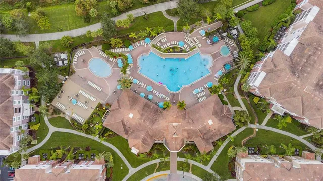 an aerial view of a house a yard and a swimming pool