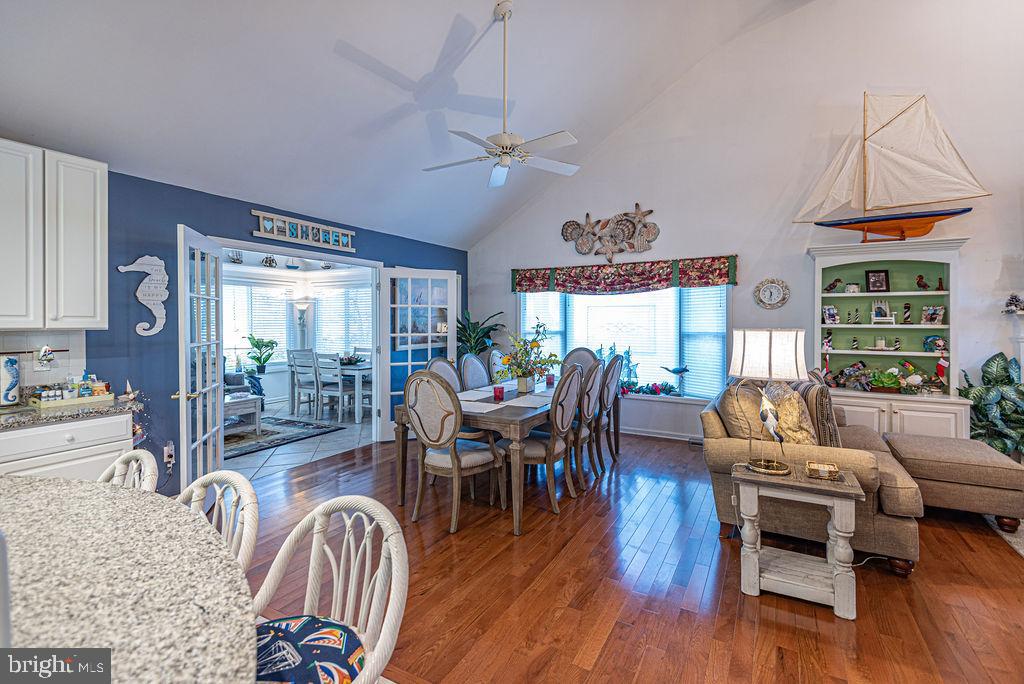 19 Mist Flower Road Ocean Pines, MD 21811 - Photo 11 of 36 a living room with furniture dining table a large window and wooden floor