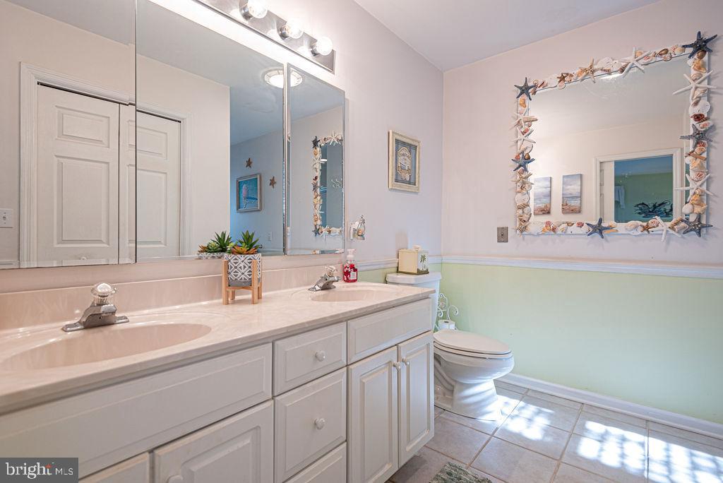 19 Mist Flower Road Ocean Pines, MD 21811 - Photo 18 of 36 a bathroom with a double vanity sink toilet and a mirror