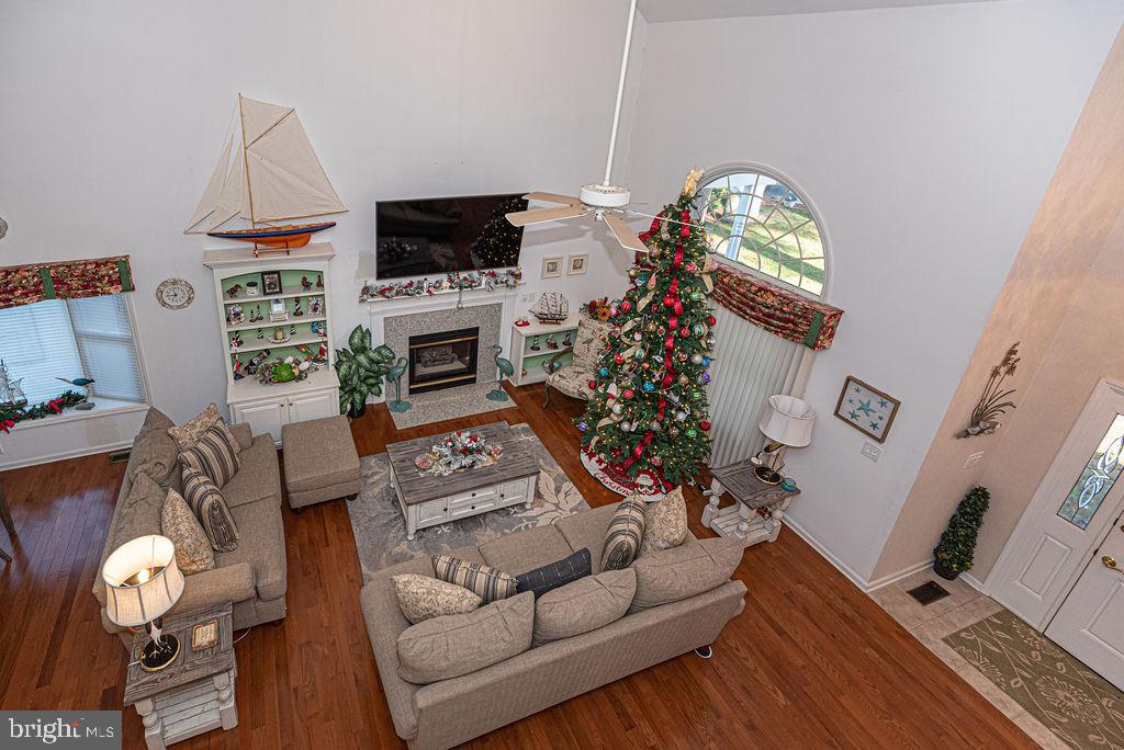 19 Mist Flower Road Ocean Pines, MD 21811 - Photo 21 of 36 a living room with furniture a fireplace and a flat screen tv