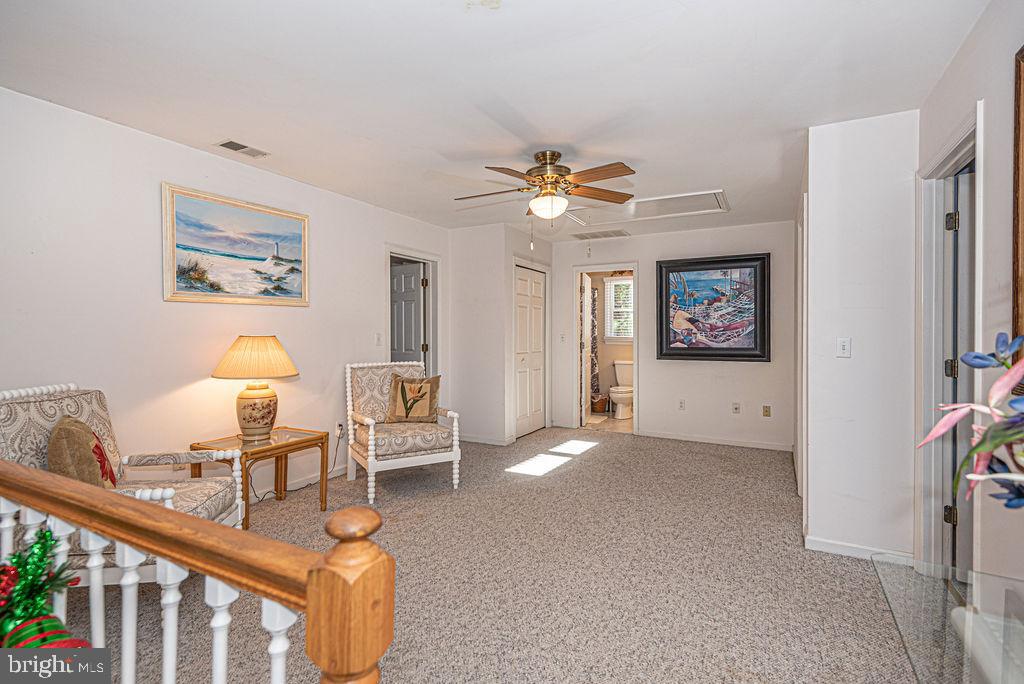 19 Mist Flower Road Ocean Pines, MD 21811 - Photo 22 of 36 a living room with furniture a chandelier and a flat screen tv
