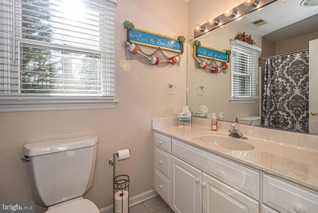 19 Mist Flower Road Ocean Pines, MD 21811 - Photo 25 of 36 a bathroom with a toilet sink and mirror