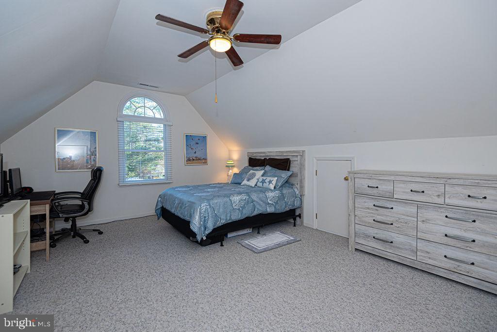 19 Mist Flower Road Ocean Pines, MD 21811 - Photo 26 of 36 a bedroom with a bed a chandelier and a window