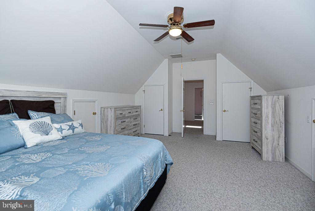 19 Mist Flower Road Ocean Pines, MD 21811 - Photo 27 of 36 a spacious bedroom with a bed and a ceiling fan