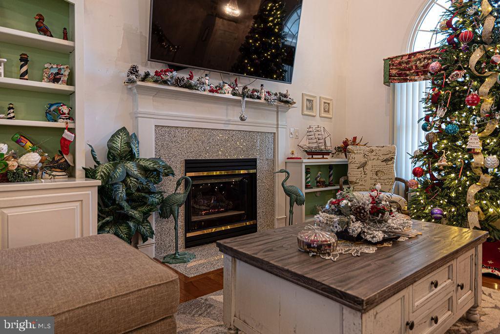19 Mist Flower Road Ocean Pines, MD 21811 - Photo 6 of 36 a kitchen with a stove a fireplace a dining table and chairs