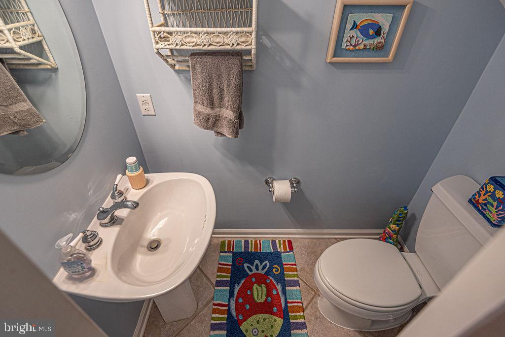 19 Mist Flower Road Ocean Pines, MD 21811 - Photo 7 of 36 a bathroom with a toilet a sink and mirror