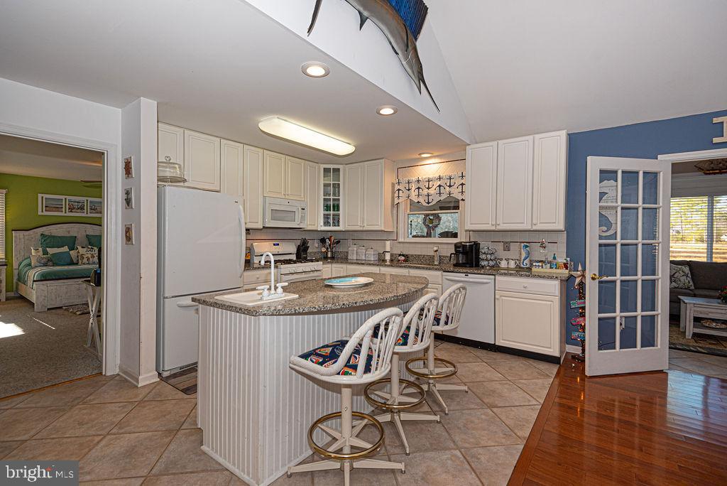 19 Mist Flower Road Ocean Pines, MD 21811 - Photo 9 of 36 a kitchen with kitchen island granite countertop a sink a counter top space and stainless steel appliances