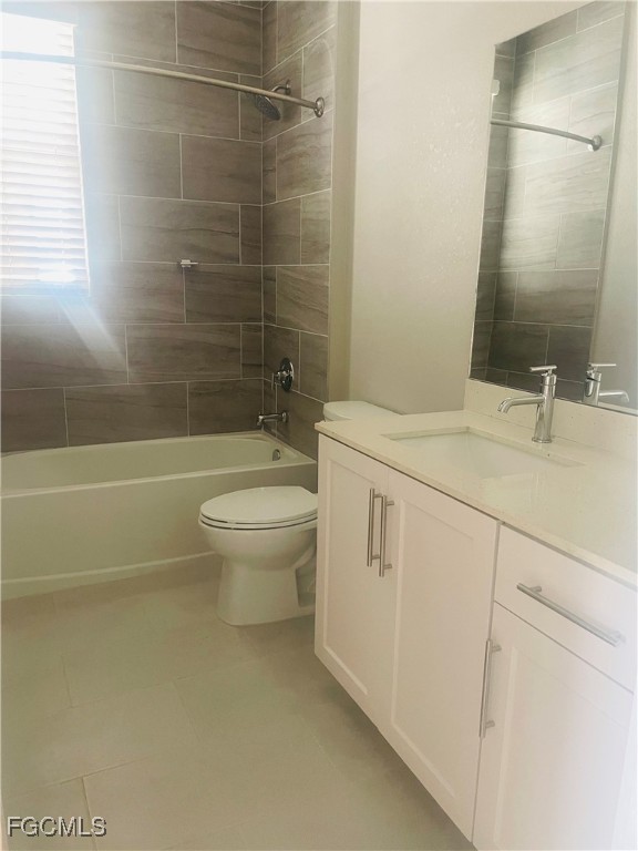 7044 Ambrosia Lane, Unit 103 Naples, FL 34119 - Photo 11 of 20 a bathroom with a sink a toilet and shower