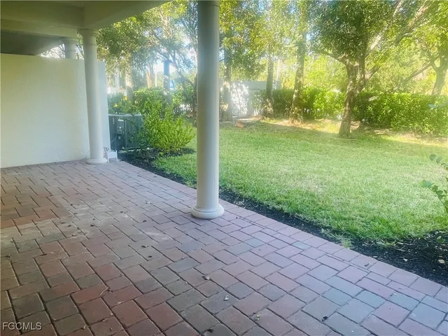 a view of a yard and an trees in the background