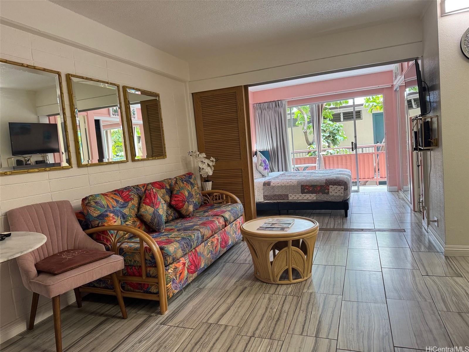 417 Nohonani Street, Unit 410 Honolulu, HI 96815 - Photo 11 of 20 a living room with furniture and a flat screen tv