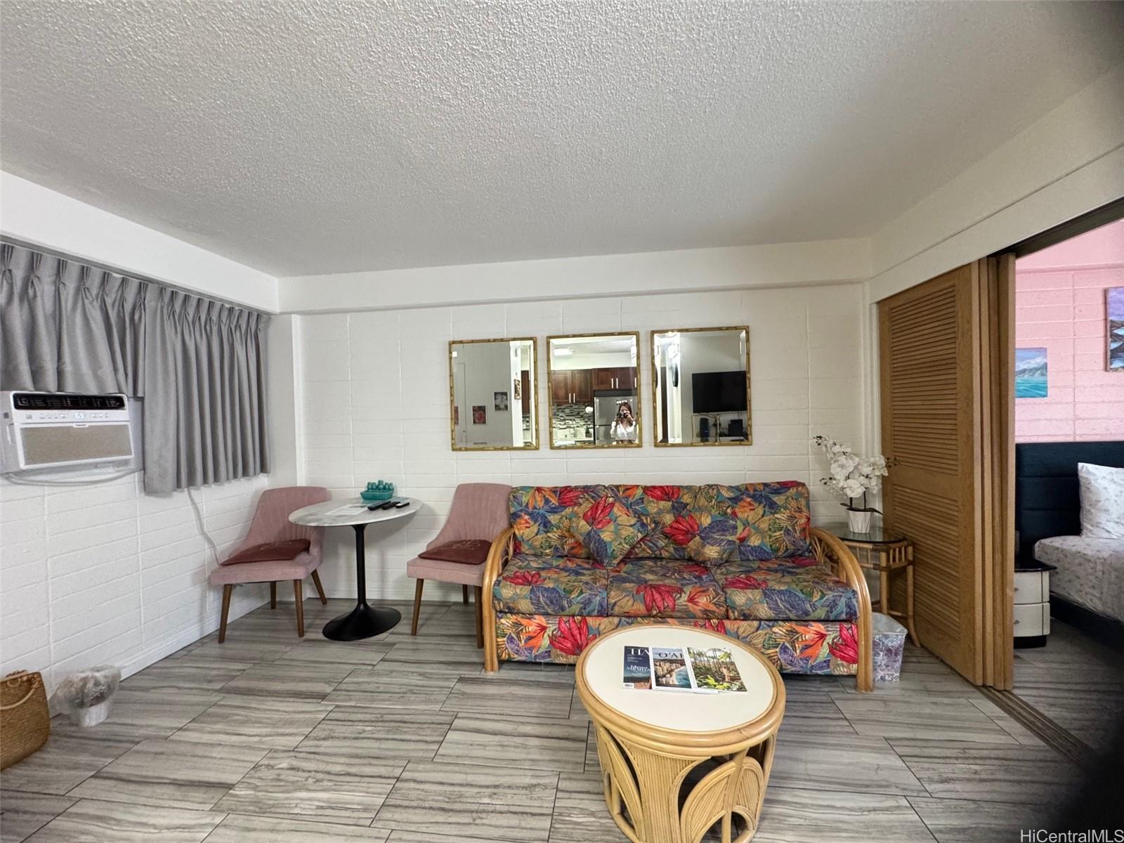 417 Nohonani Street, Unit 410 Honolulu, HI 96815 - Photo 12 of 20 a living room with furniture and a wooden floor