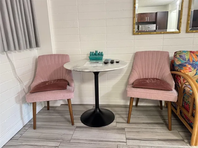 a view of a table and chairs in wooden floor