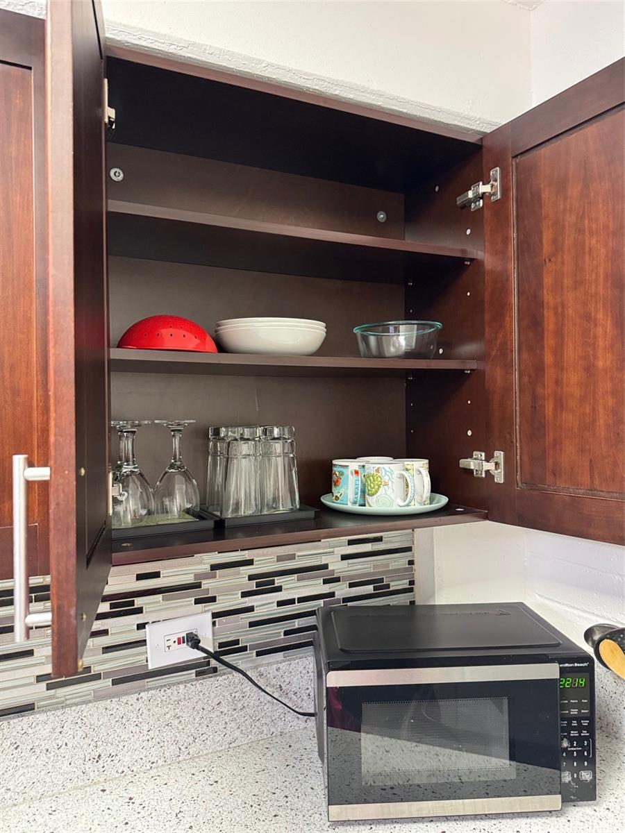 417 Nohonani Street, Unit 410 Honolulu, HI 96815 - Photo 16 of 20 a kitchen with a stove and a microwave
