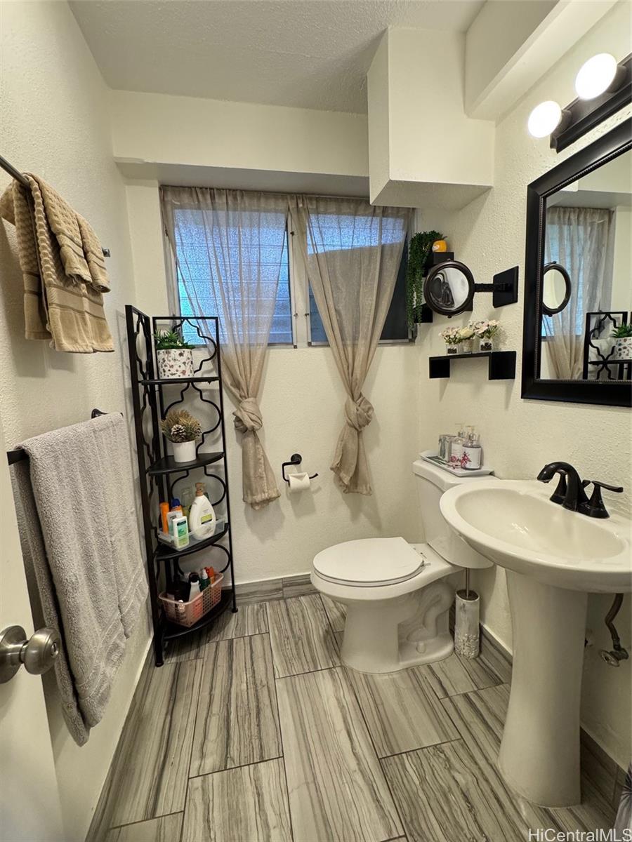 417 Nohonani Street, Unit 410 Honolulu, HI 96815 - Photo 6 of 20 a bathroom with a toilet sink and mirror