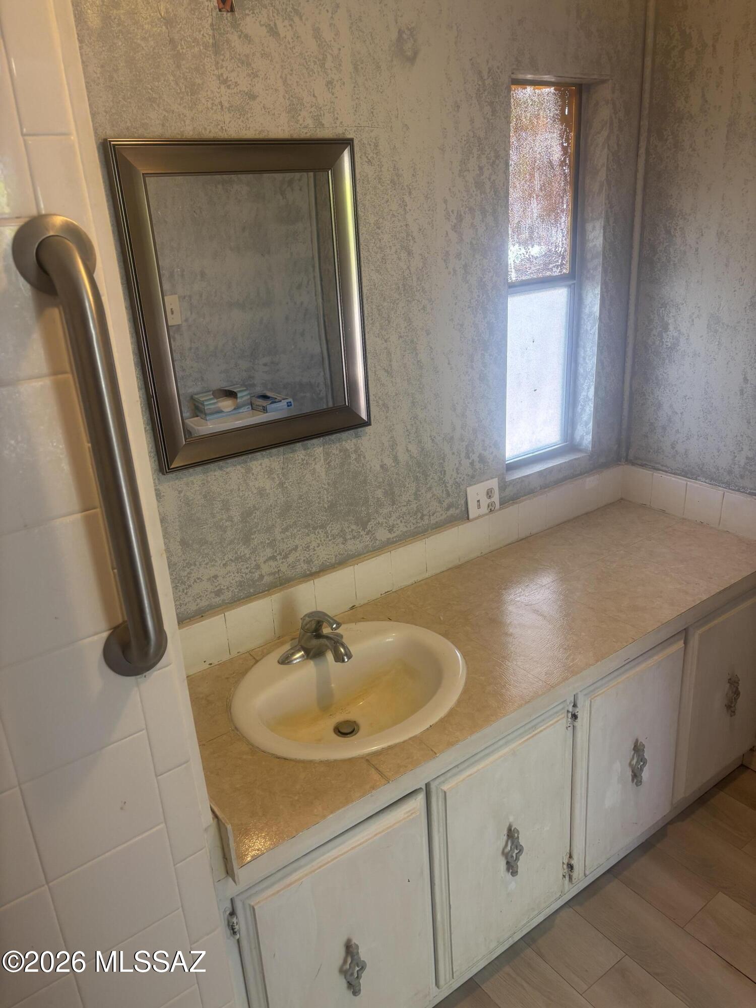 4550 North Flowing Wells Road, Unit 65 Tucson, AZ 85705 - Photo 24 of 50 a bathroom with a sink and a mirror