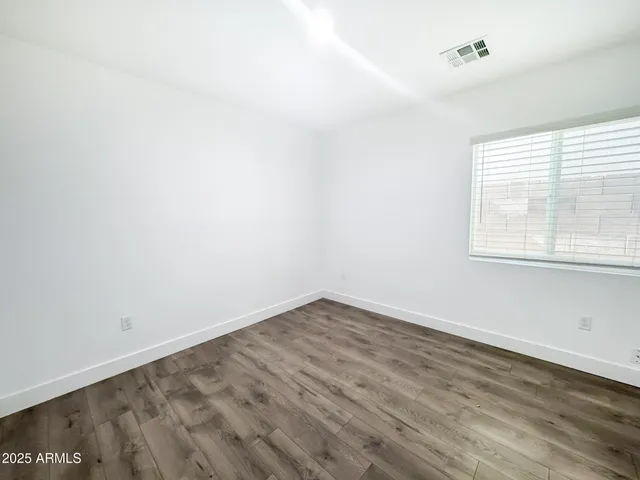 a view of a room with wooden floor