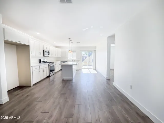 a view of a kitchen with a sink and a refrigerator