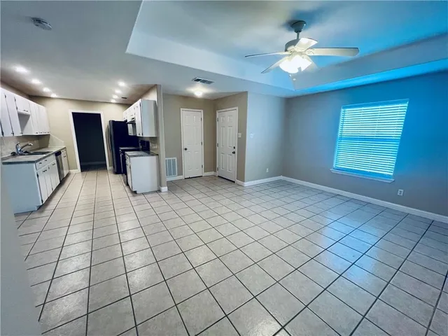 a view of kitchen with granite countertop cabinets and sink