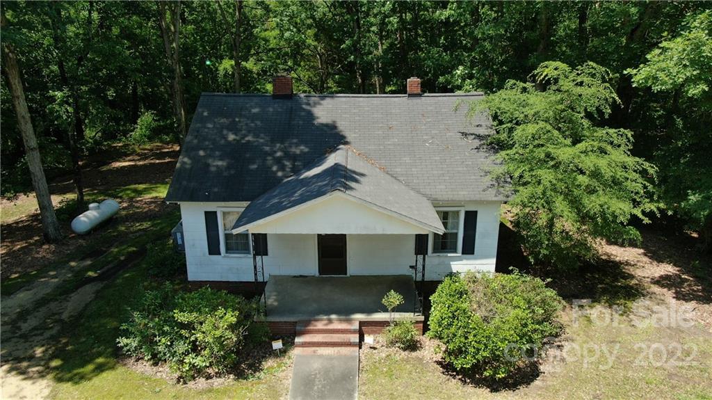 10749 Harrisburg Road Indian Land, SC 29707 - Photo 11 of 38 a front view of a house with a yard garage and outdoor seating
