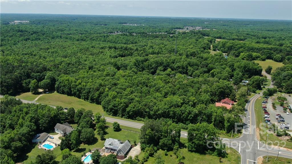 10749 Harrisburg Road Indian Land, SC 29707 - Photo 23 of 38 an aerial view of green landscape with trees houses and mountain view
