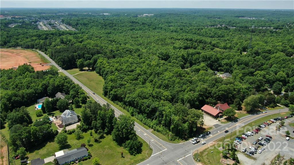 10749 Harrisburg Road Indian Land, SC 29707 - Photo 26 of 38 an aerial view of residential house with outdoor space and trees all around