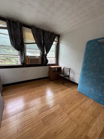 a view of room with window and wooden floor