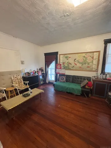 a living room with furniture and a floor to ceiling window