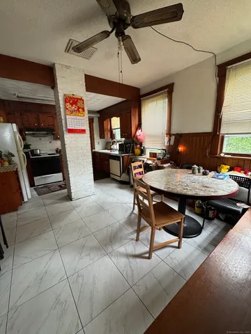 a living room with furniture a flat screen tv and a table