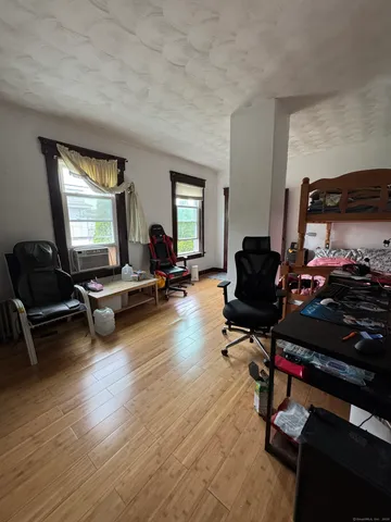 a living room with furniture gym equipment and a large window